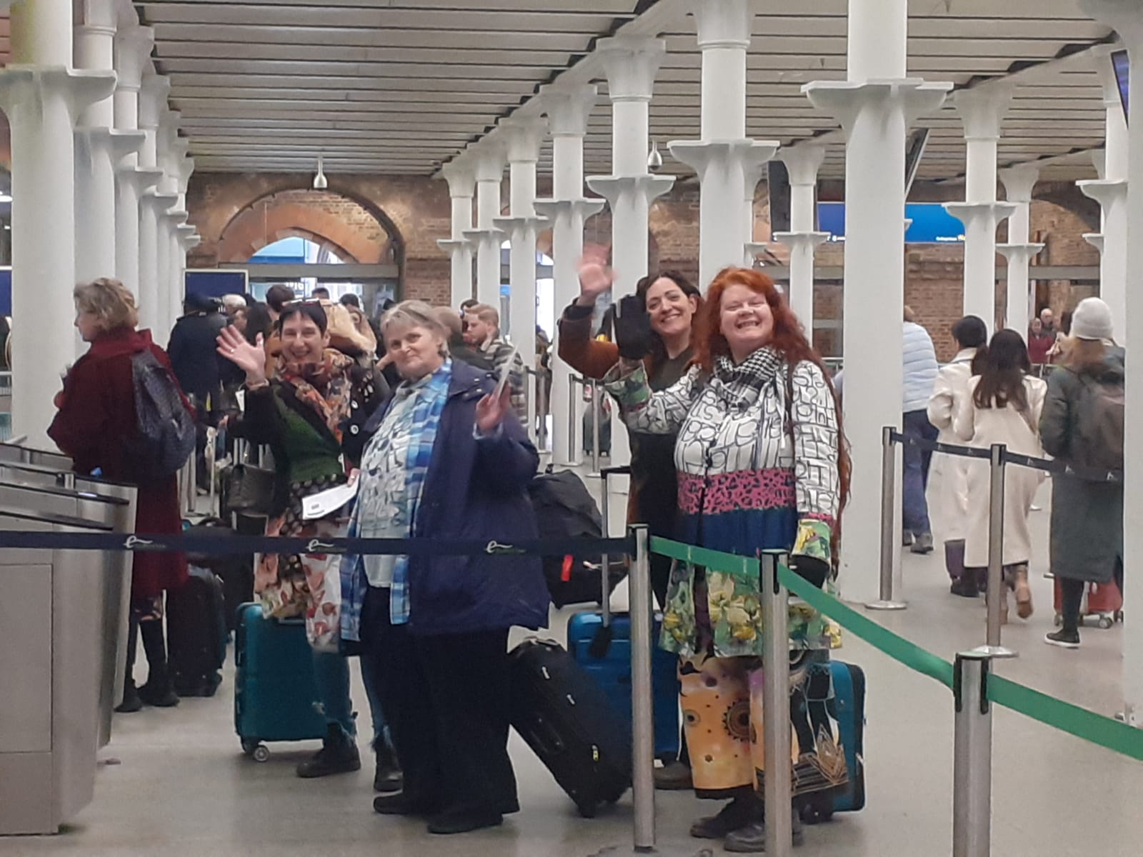 Tracey, Amanda, Laura and Julie wave to the camera as they queue to board the Eurostar to Paris